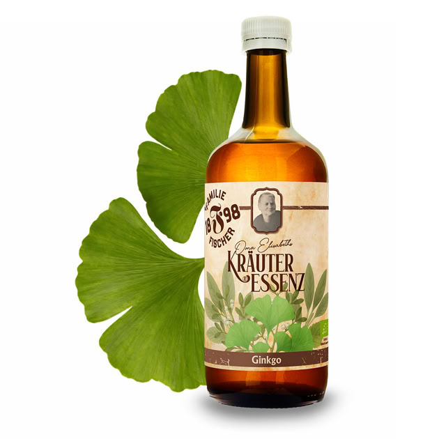 Braune Glasflasche mit Etikett "Kräuter Essenz" und zwei grünen Blättern im Hintergrund.
