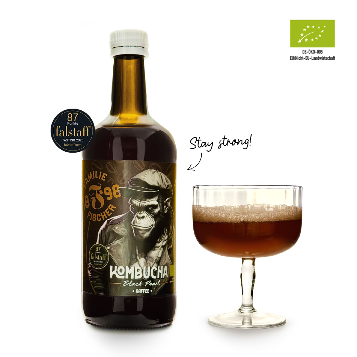Eine braune Flasche mit einem Etikett, das einen Affen zeigt, neben einem Glas mit braunem Getränk. Oben rechts ein Bio-Siegel.