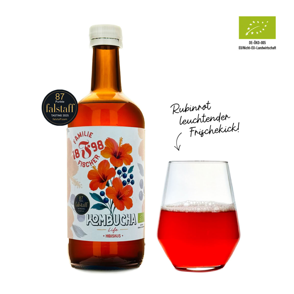 Eine Flasche mit einem Etikett mit Blumenmuster und ein Glas mit rotem Getränk daneben.